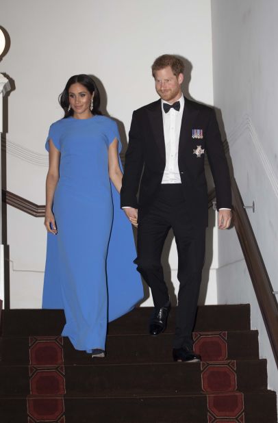 Meghan arrived for the state dinner on October 23 in Fiji wearing a blue Ginkgo cape dress by <a href="https://www.safiyaa.com/collections/dresses/products/ginkgo-cape-dress" target="_blank" target="_blank">Safiyaa</a>.