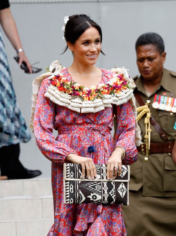 Meghan attended University of the South Pacific in Fiji wearing a printed wrap dress by <a href="https://www.modaoperandi.com/figue-pf18/frederica-printed-ruffle-dress" target="_blank" target="_blank">Figue</a> on October 24.