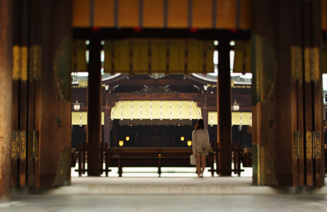 A visitor prays at Meiji shrine in Tokyo. 
