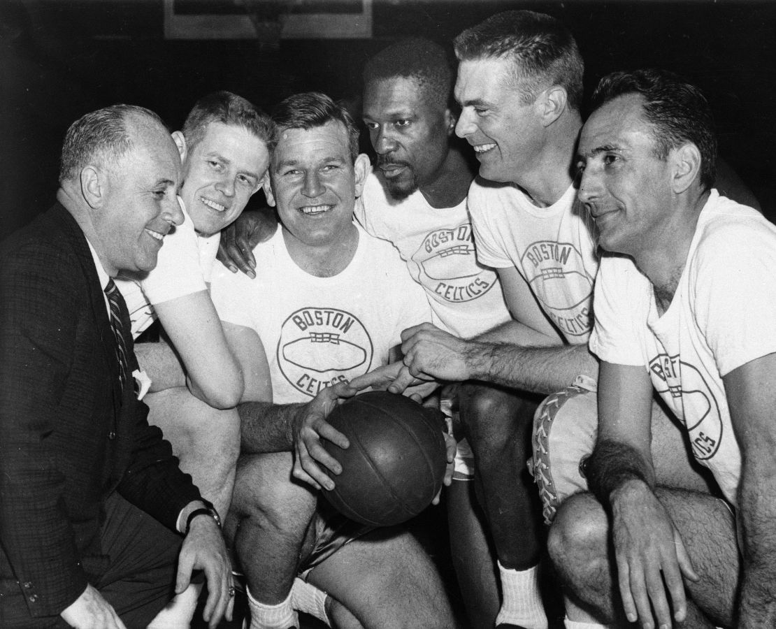 Bob Cousy, right, and Bill Russell pose for a team photo in 1963 with coach Red Auerbach.