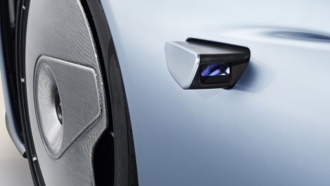 Small video cameras replace side mirrors. The front wheels are covered by stationary shields.