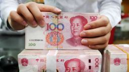 An employee counts 100-yuan notes at a bank in Nantong in China's eastern Jiangsu province on July 23, 2018. - China on July 23 rejected accusations by US President Donald Trump that it was manipulating the yuan to give its exporters an edge, saying Washington appeared "bent on provoking a trade war". (Photo by - / AFP) / China OUT        (Photo credit should read -/AFP/Getty Images)