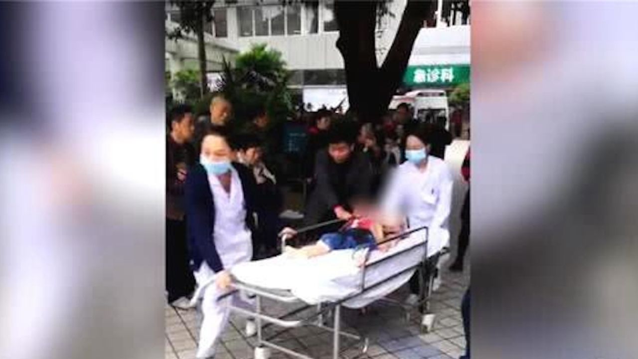 An image from state media shows children being rushed to hospital after a stabbing attack at a kindergarten in Chongqing. The child's face has been blurred.