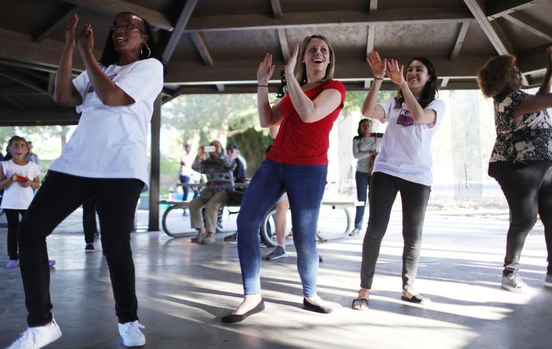 Katie Hill, center in red, dances at a campaign Halloween carnival event in Lancaster, California. 