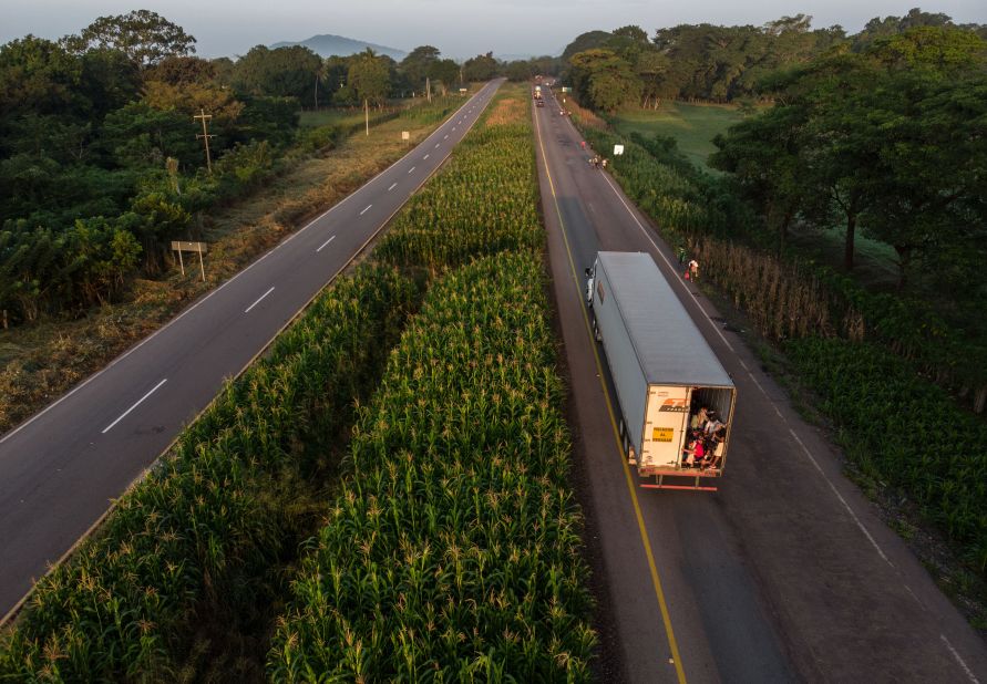 A truck of migrants heads in a caravan to the United States. Defense Secretary James Mattis is expected to sign deployment orders that could send 800 or more US troops to the border.