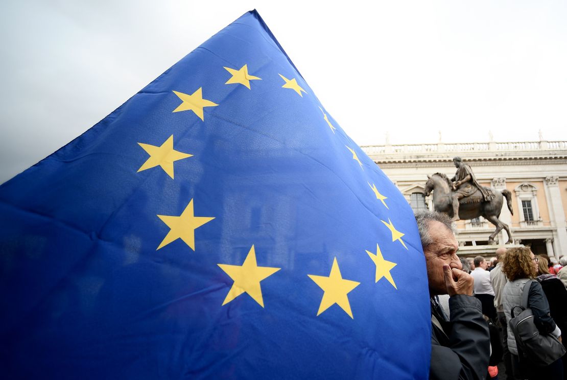 A demonstrator holds an EU flag in Rome's Piazza del Campidoglio  during a protest Saturday against decay of the capital under the populist Five Star Movement.