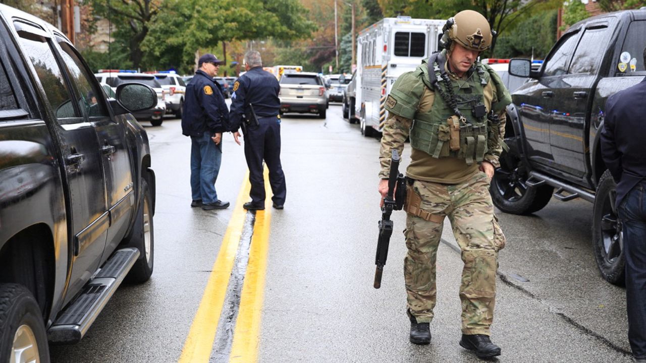 A SWAT police officer and other first responders respond after a gunman opened fire at Tree of Life.