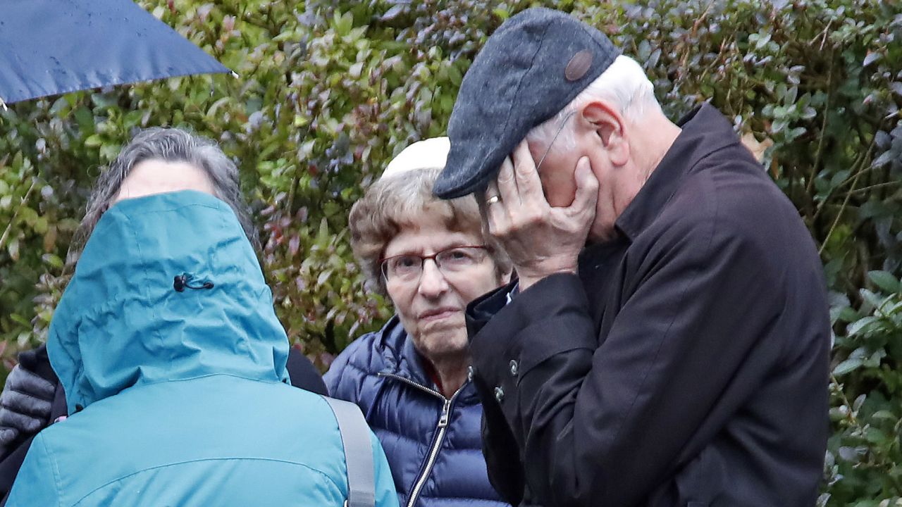 People gather on a corner near the Tree of Life Synagogue in Pittsburgh, Pa., where a shooter opened fire Saturday, Oct. 27, 2018, injuring multiple people. (AP Photo/Gene J. Puskar)