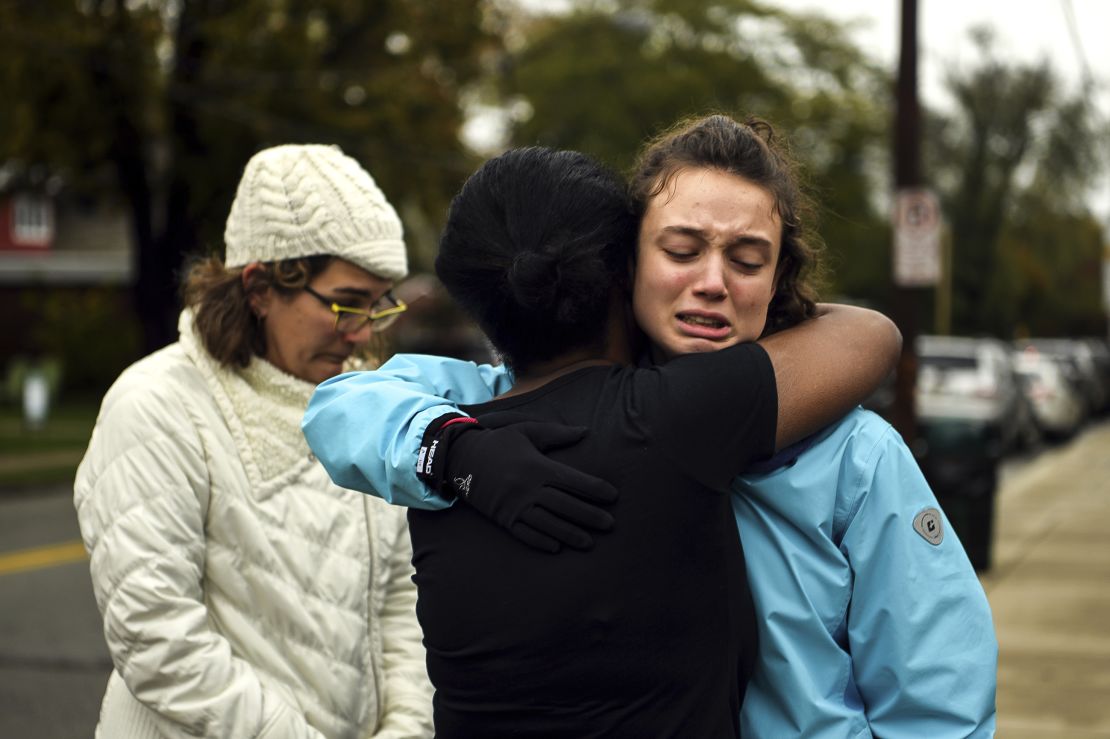 Kate Rothstein, left, looks on as Tammy Hepps hugs Simone Rothstein, 16, after multiple people were shot at The Tree of Life synagogue in Pittsburgh.