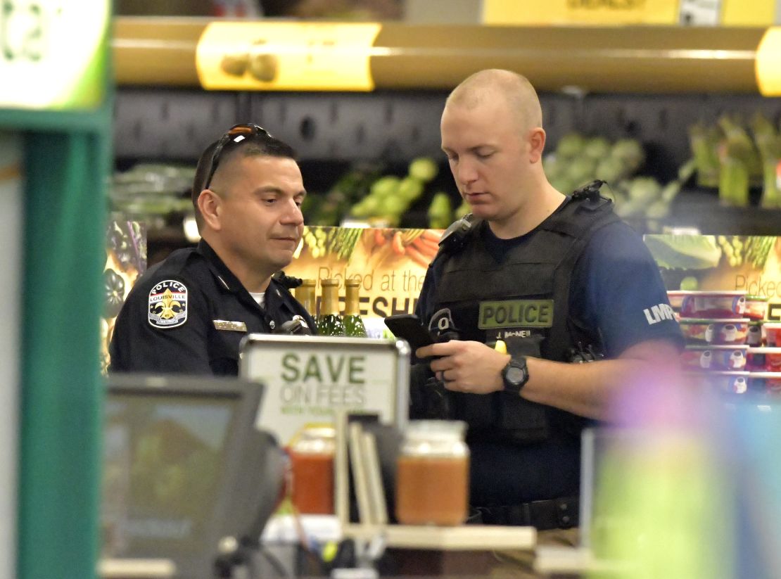Members of the Louisville Metro Police Department talk inside the Kroger grocery store in Jeffersontown, Kentucky, after Wednesday's shootings.