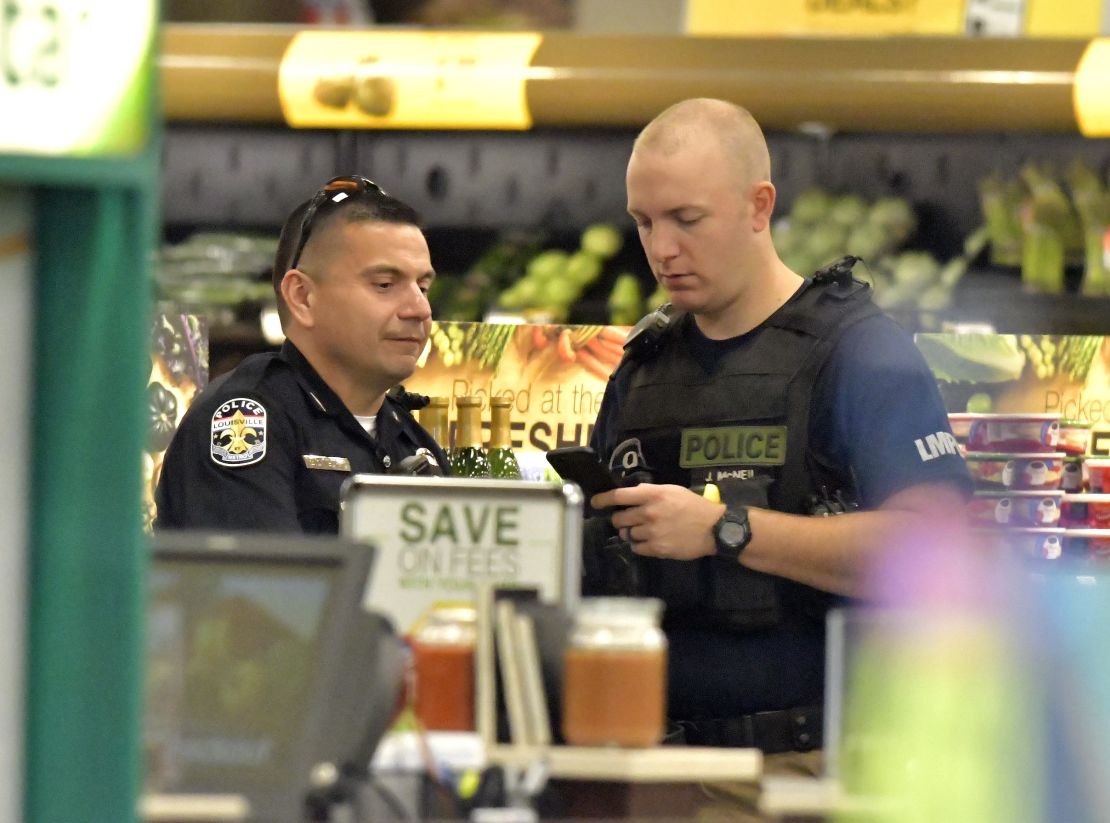 Members of the Louisville Metro Police Department talk inside a Kroger grocery in Jeffersontown, Kentucky following a shooting on Oct. 24, 2018.