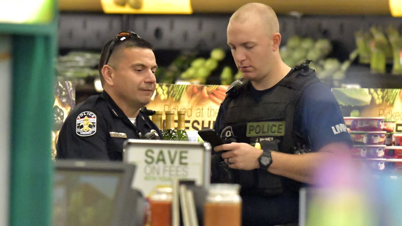 Members of the Louisville Metro Police Department talk inside a Kroger grocery in Jeffersontown, Kentucky following a shooting on Oct. 24, 2018.