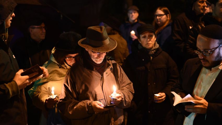 People hold candles outside the Tree of Life Synagogue after a shooting there left 11 people dead in the Squirrel Hill neighborhood of Pittsburgh on October 27, 2018. - A heavily armed gunman opened fire during a baby-naming ceremony at a synagogue in the US city of Pittsburgh on October 27, killing 11 people and injuring six in the deadliest anti-Semitic attack in recent American history. (Photo by Brendan Smialowski / AFP)        (Photo credit should read BRENDAN SMIALOWSKI/AFP/Getty Images)