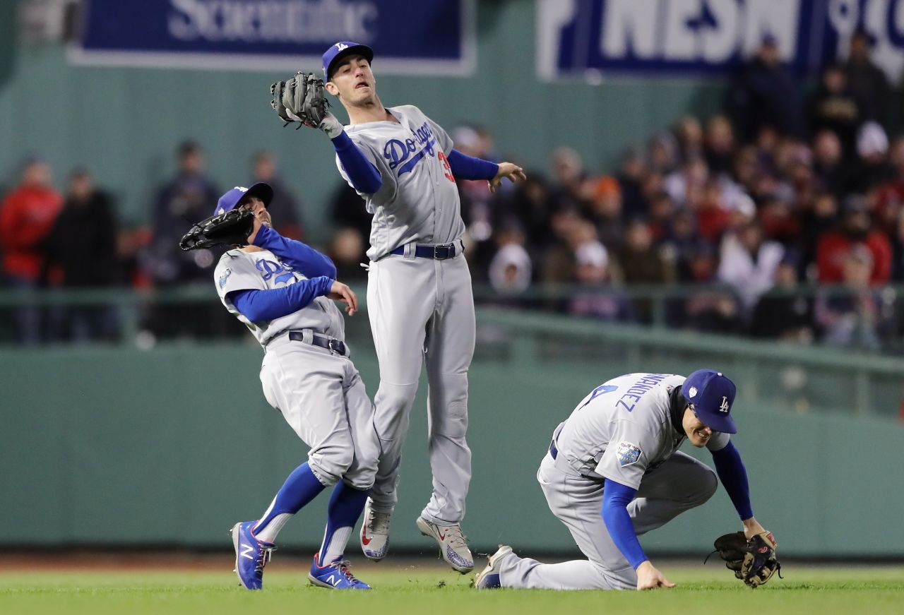 Cody Bellinger of the Los Angeles Dodgers narrowly avoids teammates Chris Taylor and Enrique Hernandez while making a catch during the sixth inning of Game 2.