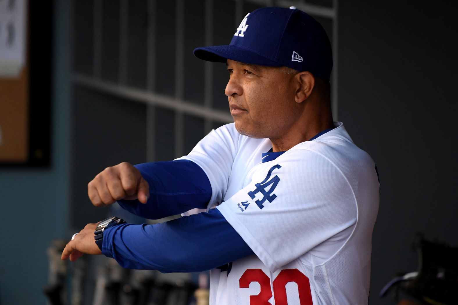 Dave Roberts of the Dodgers looks on from the dugout before Game 3.