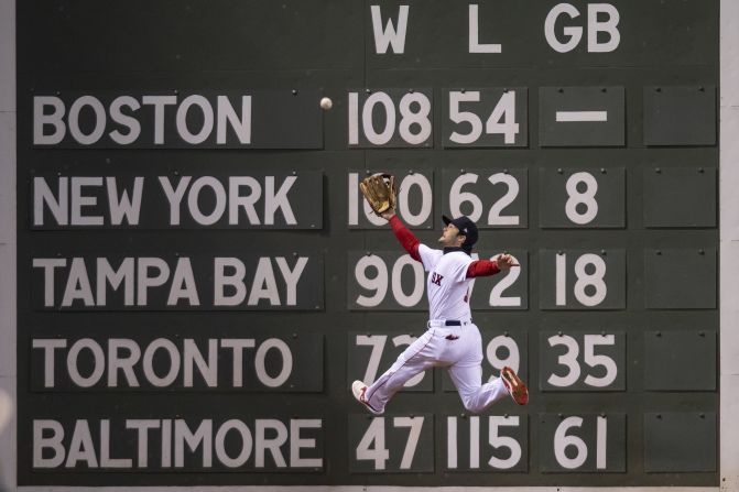 Andrew Benintendi of the Red Sox makes a leaping catch in front of the Green Monster at Fenway Park on a ball hit by Brian Dozier of the Dodgers during the fifth inning of Game 2  of the series on Wednesday, October 24.