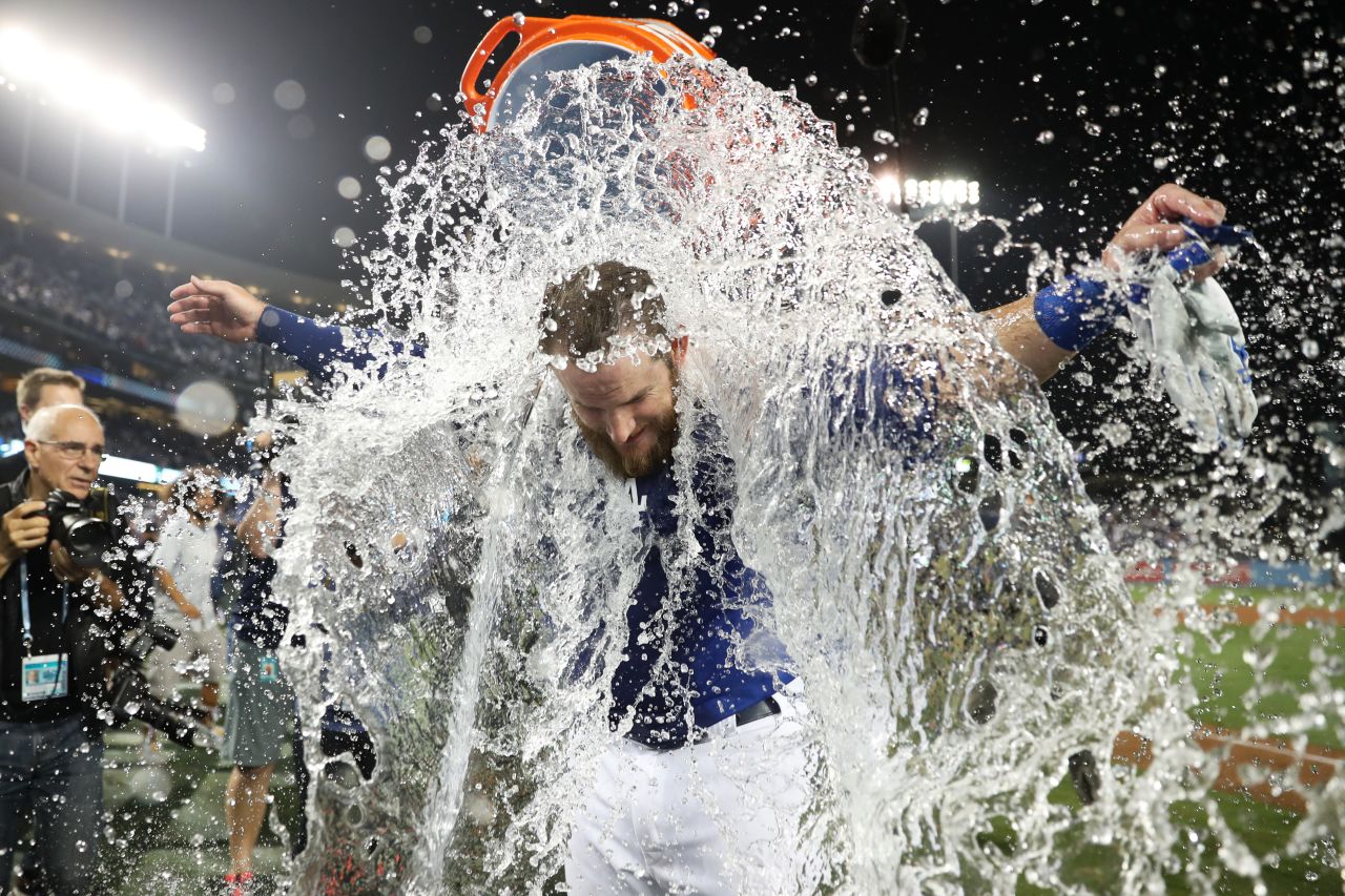 Max Muncy of the Dodgers is doused with water after his winning run in Game 4.