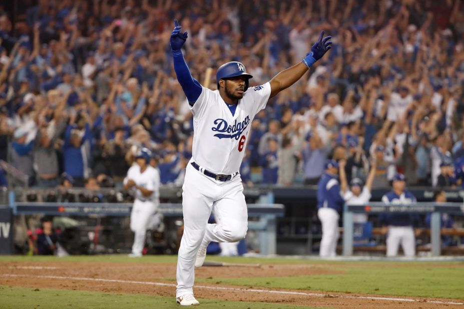 Yasiel Puig of the Dodgers celebrates on his way to first base after hitting a three-run home run to left field in the sixth inning of Game 4 of the series against Red Sox pitcher Eduardo Rodriguez at Dodger Stadium.