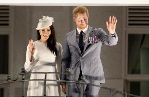 Harry and Meghan wave from the balcony of the Grand Pacific Hotel in Suva, Fiji, on Tuesday, October 23.