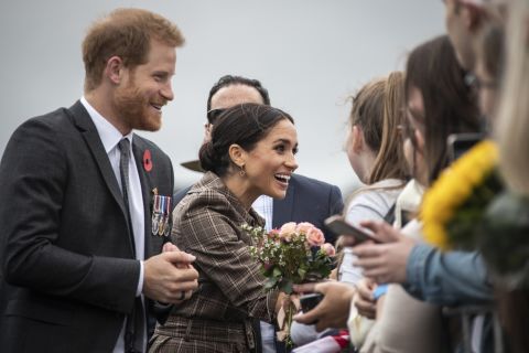 Britain's Prince Harry and Meghan, Duchess of Sussex, greet the crowd as they visit the newly unveiled UK war memorial and Pukeahu National War Memorial Park in in Wellington, New Zealand, on Sunday, October 28.