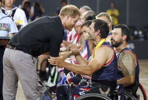 Prince Harry congratulates a member of the United States wheelchair basketball team after the team won the gold medal in the finals of the Invictus Games in Sydney on Saturday, October 27.