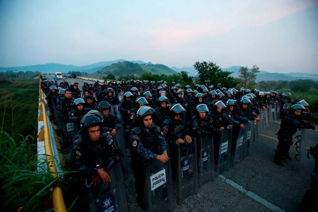 A wall of police in riot gear blocked a highway to stop thousands of migrants in the Mexican state of Chiapas on Saturday.