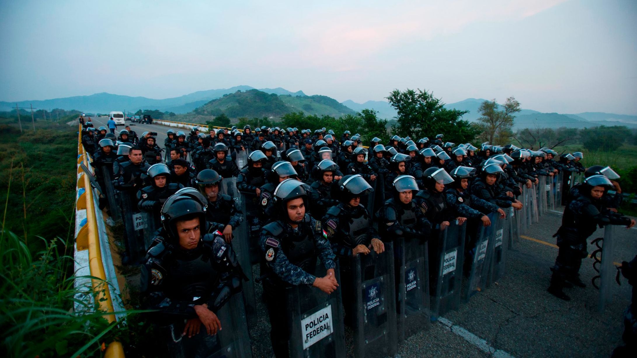A wall of police in riot gear blocked a highway to stop thousands of migrants in the Mexican state of Chiapas on Saturday.