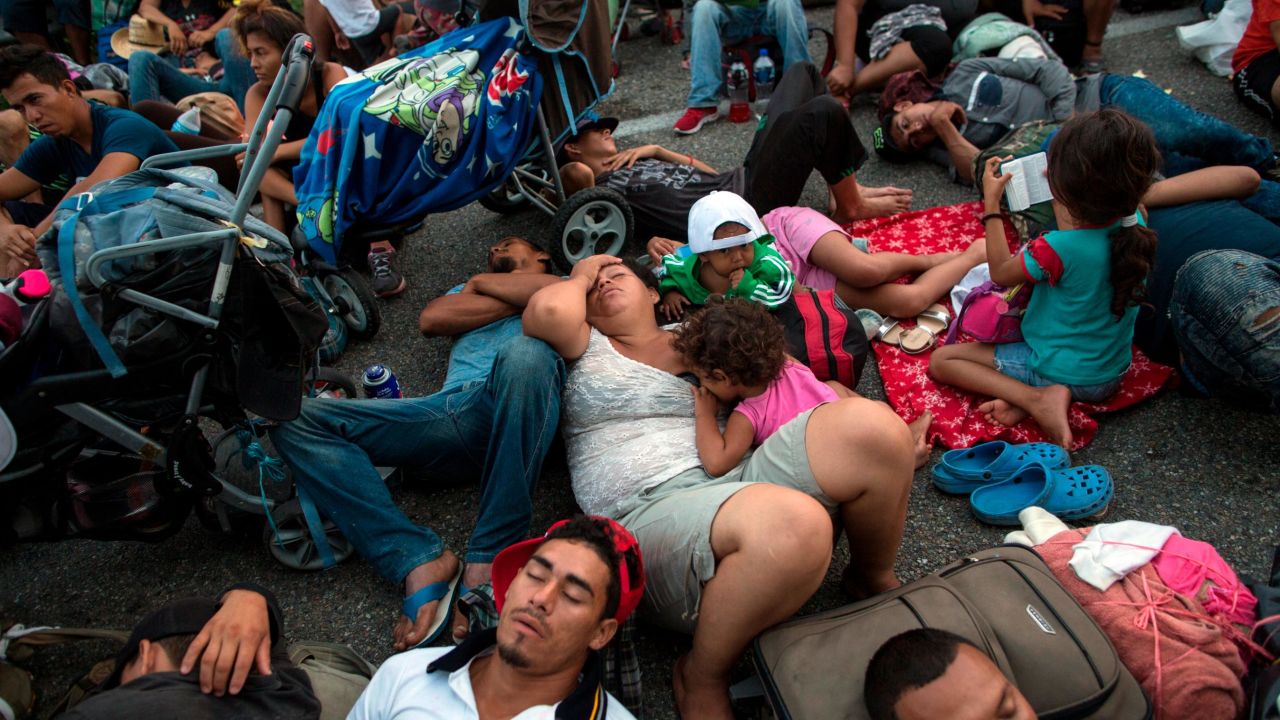 Members of a US-bound migrant caravan rest on a road between the Mexican states of Chiapas and Oaxaca after federal police briefly blocked them outside the town of Arriaga, Saturday, Oct. 27, 2018. Hundreds of Mexican federal officers carrying plastic shields had blocked the caravan from advancing toward the United States, after several thousand of the migrants turned down the chance to apply for refugee status and obtain a Mexican offer of benefits. (AP Photo/Rodrigo Abd)