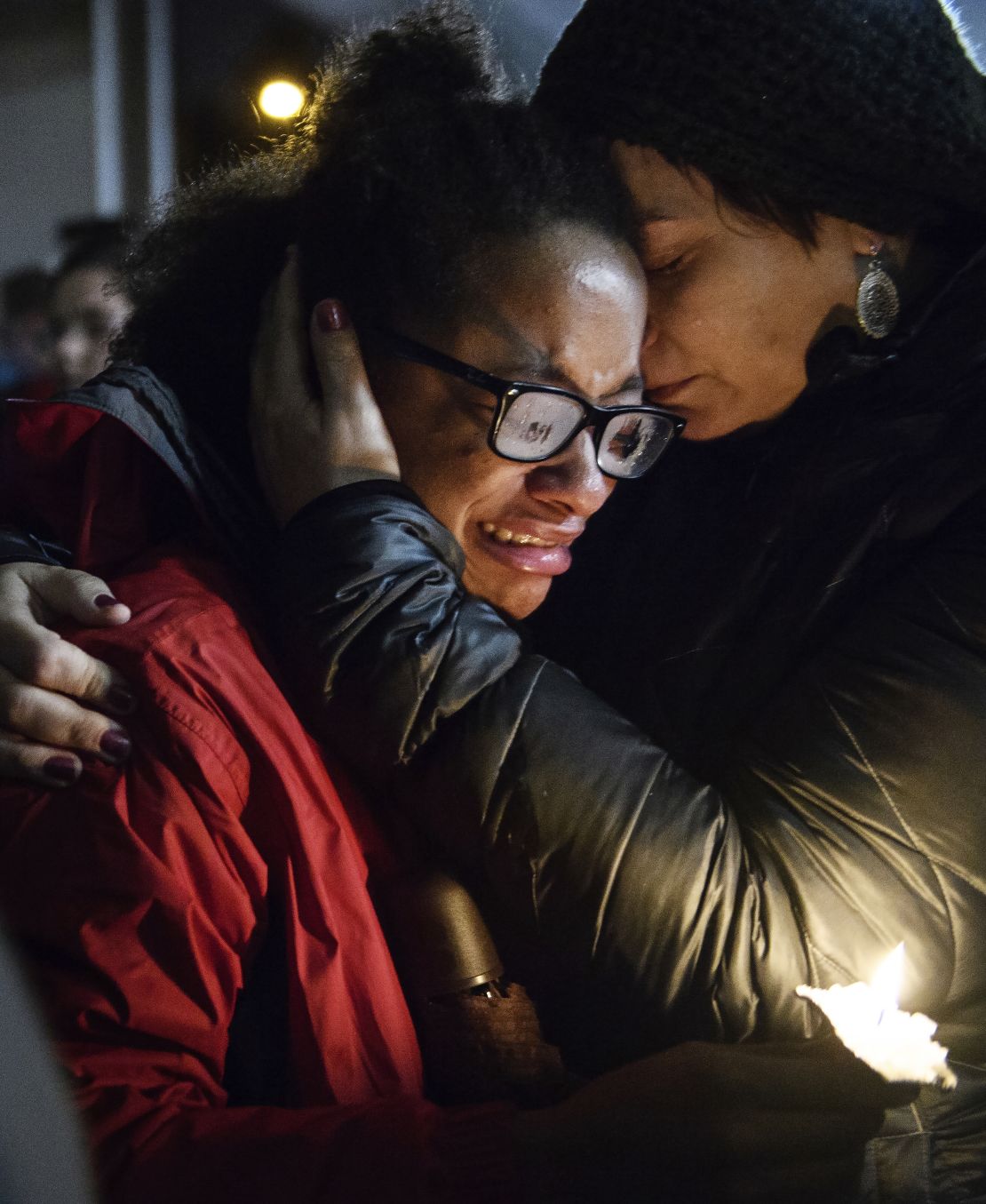 Isabel Kinnane Smith of Taylor Allderdice High School is comforted by Lesley Britton, a math teacher at the school, during a vigil Saturday in Pittsburgh. 