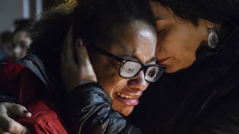 Isabel Kinnane Smith of Taylor Allderdice High School is comforted by Lesley Britton, a math teacher at the school, during a vigil Saturday in Pittsburgh. 