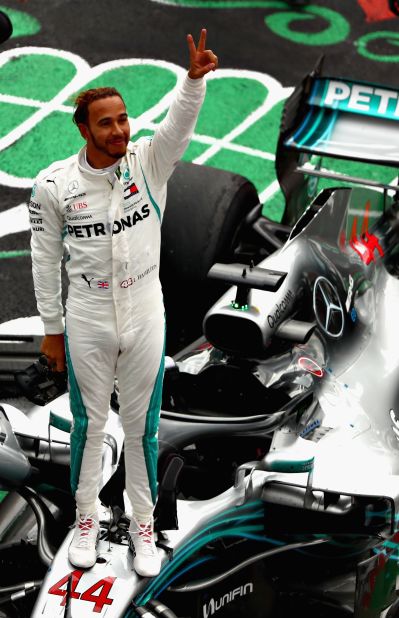 Lewis Hamilton savors the moment after clinching his fifth F1 world title with fourth place behind Max Verstappen in the Mexican Grand Prix. 