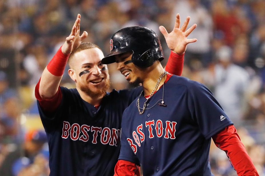 Mookie Betts of the Boston Red Sox is congratulated by his teammate Christian Vazquez after his sixth-inning home run against the Los Angeles Dodgers in Game 5.