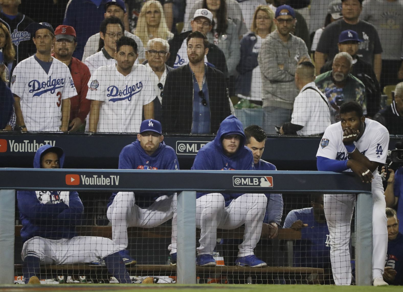 The Los Angeles Dodgers watch the eighth inning of Game 5 from the dugout.