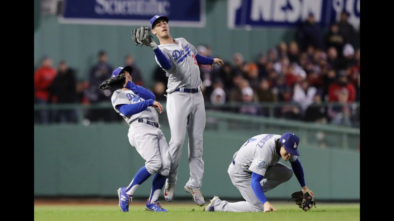 Los Angeles' Cody Bellinger makes a catch while narrowly avoiding teammates Chris Taylor and Enrique Hernandez during Game 2 of the World Series on Wednesday, October 24.