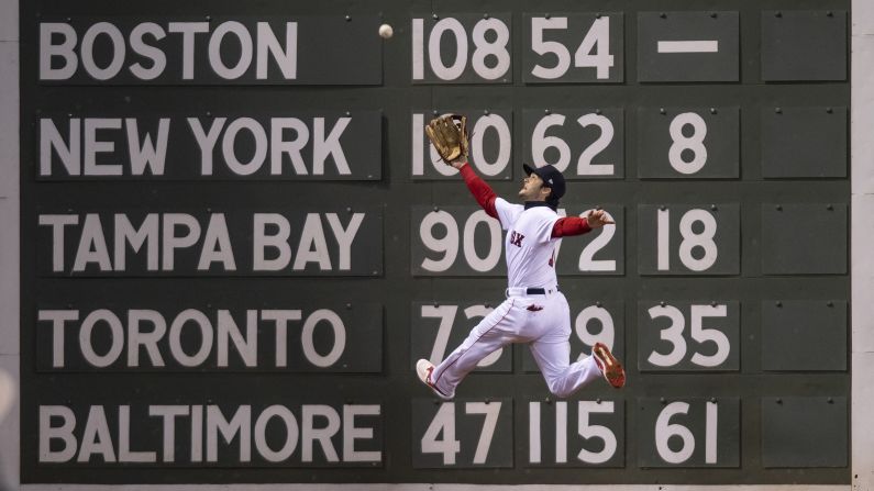 Boston's Andrew Benintendi makes a leaping catch in front of Fenway Park's Green Monster during Game 2 of the World Series on Wednesday, October 24.