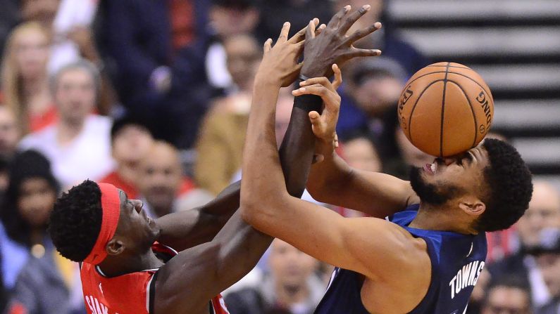 Toronto's Pascal Siakam and Minnesota's Karl-Anthony Towns fight over a loose ball during an NBA game in Toronto on Wednesday, October 24. <a  target="_blank">See 36 amazing sports photos from last week</a>