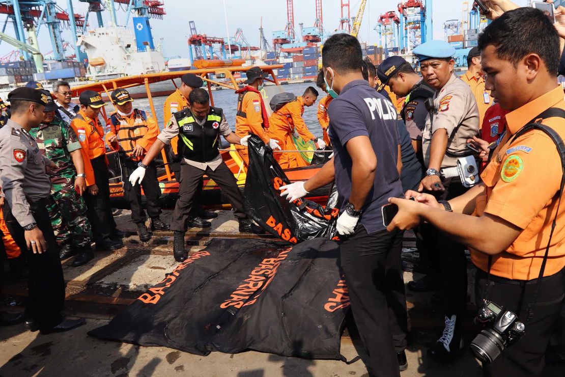 Members of a rescue team line up body bags in Tanjung Priok, North Jakarta, on Monday.
