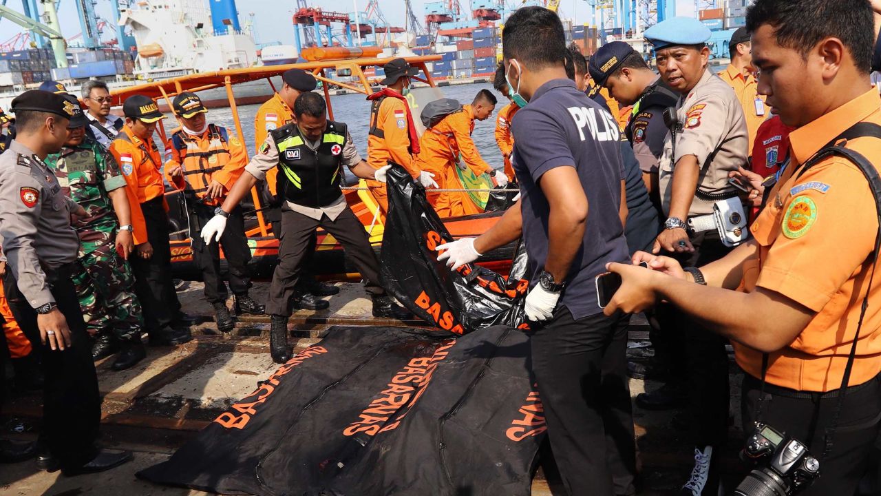 Members of a rescue team line up body bags in Tanjung Priok, North Jakarta, on Monday.