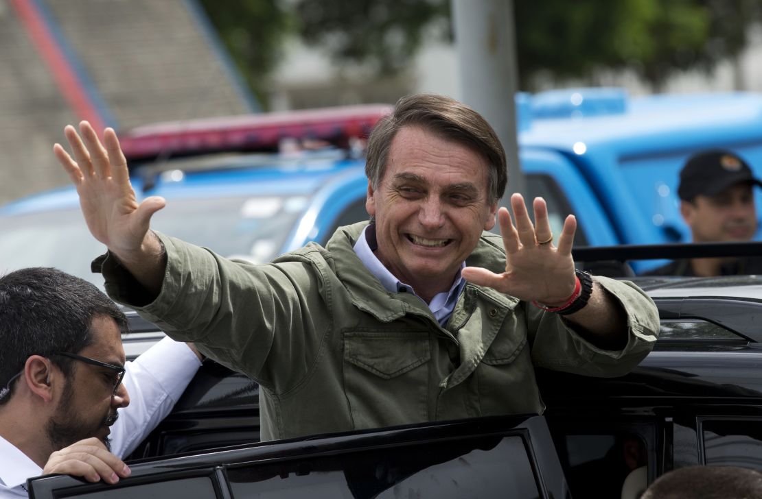 Jair Bolsonaro waves after voting in the presidential runoff election in Rio de Janeiro on October 28.