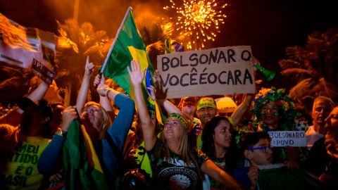 Supporters of far-right presidential candidate Jair Bolsonaro celebrate in front of his house in Rio de Janeiro on October 28.