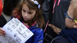 A girl holds thank-you notes on October 28, 2018 outside of the Tree of Life Synagogue after a shooting there left 11 people dead in the Squirrel Hill neighborhood of Pittsburgh on October 27, 2018. - A man suspected of bursting into a Pittsburgh synagogue during a baby-naming ceremony and gunning down 11 people has been charged with murder, in the deadliest anti-Semitic attack in recent US history. The suspect -- identified as a 46-year-old Robert Bowers -- reportedly yelled "All Jews must die" as he sprayed bullets into the Tree of Life synagogue during Sabbath services on Saturday before exchanging fire with police, in an attack that also wounded six people. (Photo by Brendan Smialowski / AFP)        (Photo credit should read BRENDAN SMIALOWSKI/AFP/Getty Images)