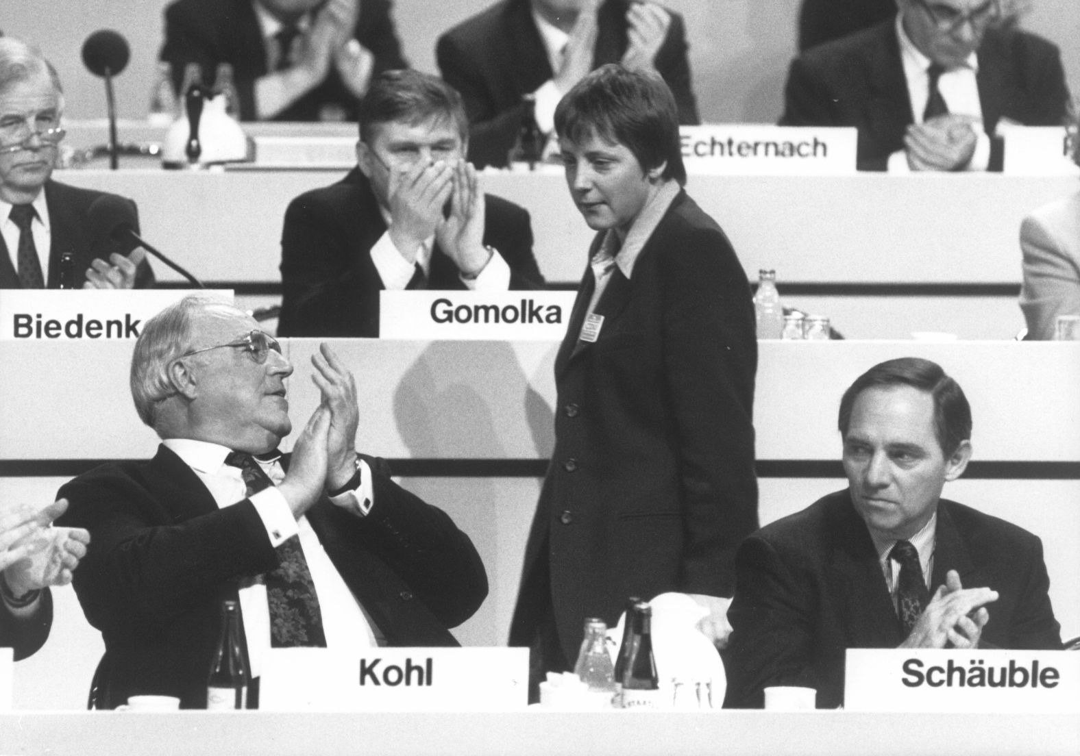 Merkel looks at Kohl during a conference of the Christian Democratic Union, their political party, in 1991. At the time, Merkel was a deputy chairwoman for the party.