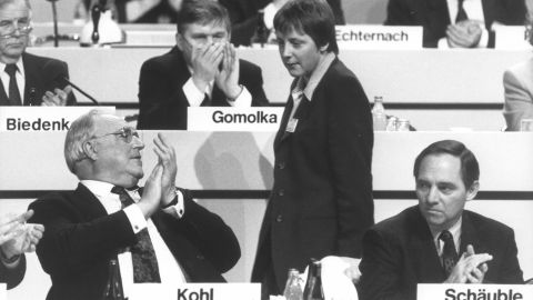 Merkel looks at Kohl during a conference of the Christian Democratic Union, their political party, in 1991. At the time, Merkel was a deputy chairwoman for the party.