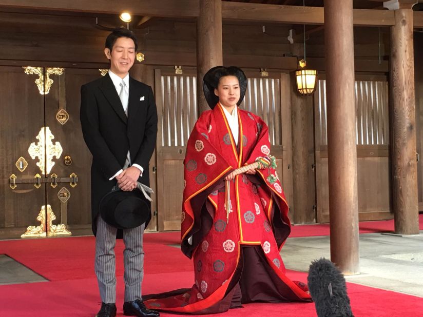 Japan's Princess Ayako and her new husband Kei Moriya speak to reporters after their marriage ceremony in the Meiji Shrine in Tokyo on October 29, 2018. 