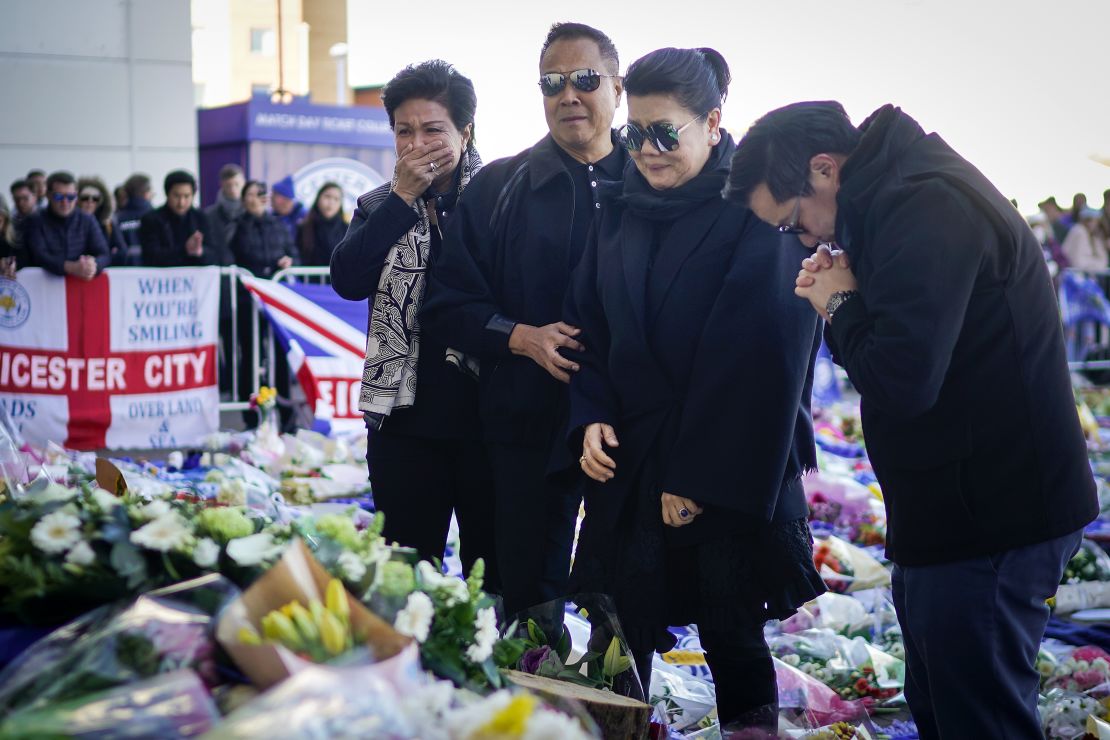 Aimon Srivaddhanaprabha (second right), the wife of the late Leicester owner, and their son Aiyawatt lay wreathes at the club.