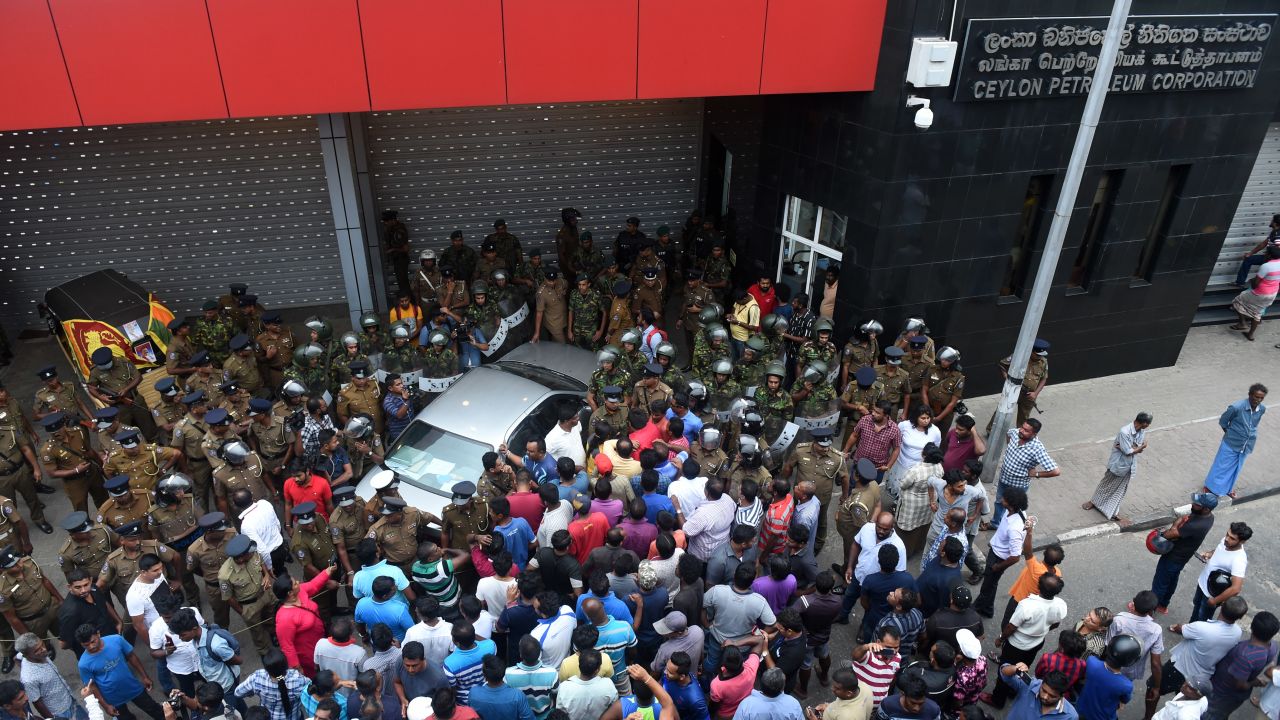 Sri Lankan police keep watch outside the Ceylon Petroleum Corporation in Colombo on October 28, 2018.