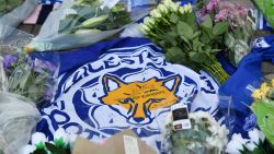 A flag showing the Leicester City Football Club's Fox logo with a message of thanks is seen in a growing pile of tributes outside Leicester City Football Club's King Power Stadium in Leicester, eastern England, on October 28, 2018 after a helicopter belonging to the club's Thai chairman Vichai Srivaddhanaprabha crashed outside the stadium the night before. - Leicester City's charismatic Thai chairman was the subject of growing concerns on October 28 after a helicopter belonging to the billionaire crashed and burst into flames in the stadium carpark shortly after taking off from the club's pitch following the match against West Ham United on October 27. There was no confirmation whether London-based Vichai Srivaddhanaprabha, who frequently flies to and from Leicester's home games by helicopter, was on board the aircraft which appeared to develop mechanical problems. (Photo by Ben STANSALL / AFP)        (Photo credit should read BEN STANSALL/AFP/Getty Images)