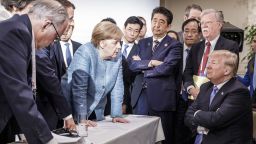 CHARLEVOIX, CANADA - JUNE 9:   In this photo provided by the German Government Press Office (BPA), German Chancellor Angela Merkel deliberates with US president Donald Trump on the sidelines of the official agenda on the second day of the G7 summit on June 9, 2018 in Charlevoix, Canada. Also pictured are (L-R) Larry Kudlow, director of the US National Economic Council, Theresa May, UK prime minister, Emmanuel Macron, French president, Angela Merkel, Yasutoshi Nishimura, Japanese deputy chief cabinet secretary, Shinzo Abe, Japan prime minister, Kazuyuki Yamazaki, Japanese senior deputy minister for foreign affairs, John Bolton, US national security adviser, and Donald Trump. Canada are hosting the leaders of the UK, Italy, the US, France, Germany and Japan for the two day summit. 