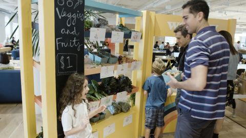 Some WeGrow members sell goods from the farm to WeWork staff.