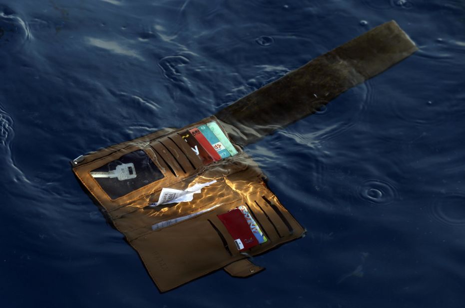 A wallet is seen in the water where the plane went down.